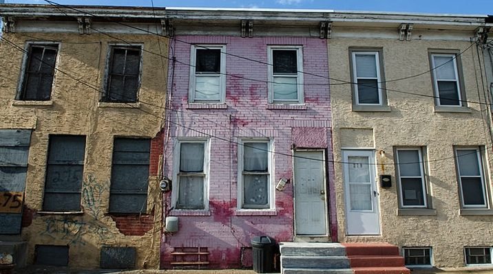 Decoration only: A photo of three row homes in apparent disrepair in Camden, NJ.