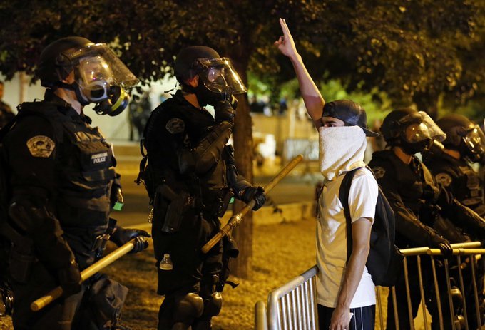 Decoration only: A protester confronts a line of heavily-armed U.S. riot police.