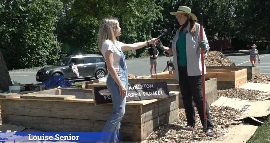 A reporter interviews a member of the Princeton Free Garden Project.