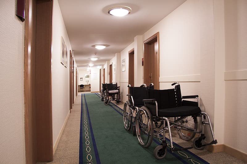 Several empty wheelchairs in a hallway.